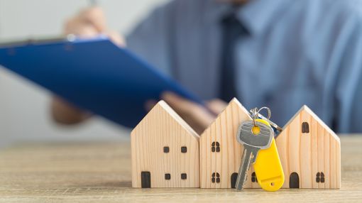 Image of a key next to the two window houses.